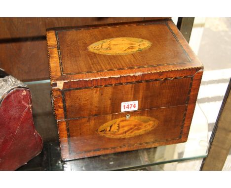 A George III mahogany and inlaid decanter box, in the Sheraton style, the hinged lid enclosing six clear glass and gilt decan