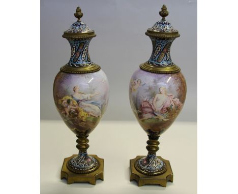 A good pair of late 19th century Sevres, champleve enamel and gilt metal urns and covers, each finely painted with a maiden a