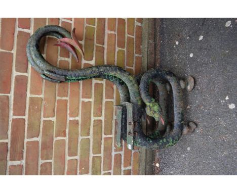 A pair of antique cast iron serpent garden bench ends.   Condition Report:  Both appear complete. Several layers of print fla