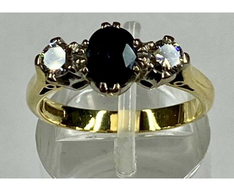 18CT GOLD RING SET WITH CENTRAL SAPPHIRE, flanked with diamond to either side, sapphire approx. 1ct, diamonds approx. 0.5ct t