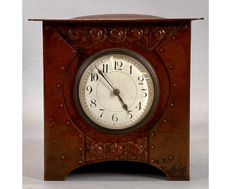 ARTS & CRAFTS MANTEL CLOCK in embossed copper case, circular white dial with Arabic numerals, 8-day movement, 20 (h) x 20 (w)