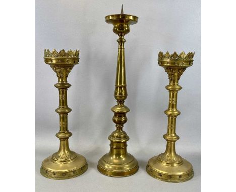 PAIR OF GOTHIC GILDED BRASS ECCLESIASTICAL PRICKET CANDLESTICKS, late 19th century with castellated drip tray, engraved stems