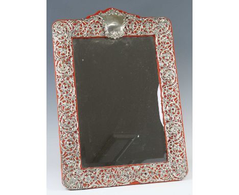 An Edwardian Art Nouveau silver clad easel dressing table mirror, having a rectangular mirrorplate within a foliate scrolling