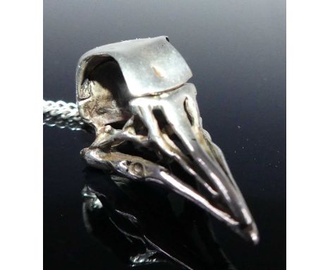 A white metal vinaigrette pendant in the form of a bird's skull, the hinged cranium opening to reveal sponge section at the r