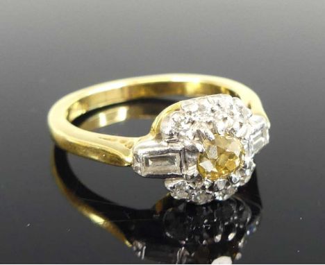 A yellow and white metal diamond circular cluster ring, featuring a centre fancy light brown Old European cut diamond within 