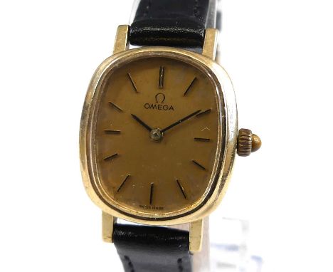 A lady's Omega 9ct gold cased manual wind wristwatch, having a signed gilded oval dial with baton markers, cal.625 manual win