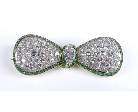 A yellow and white metal, emerald and diamond bow brooch, comprising 123 transitional Old European brilliant and Asscher cut 