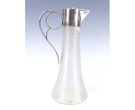 An Austrian Art Deco silver topped glass carafe, the conical body having concentric ring banded decoration and spiral ringed 