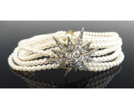 A six-row cultured pearl bracelet, featuring 392 approx 3.25mm pearls strung plain to a yellow metal engine turned bar clasp,