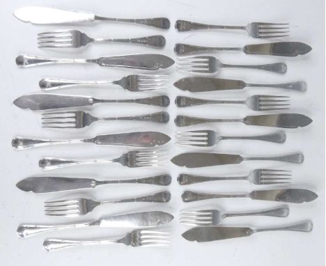 A suite of Edwardian silver dessert cutlery, in the Ribbon &amp; Thread pattern with monogrammed terminals, comprising twelve