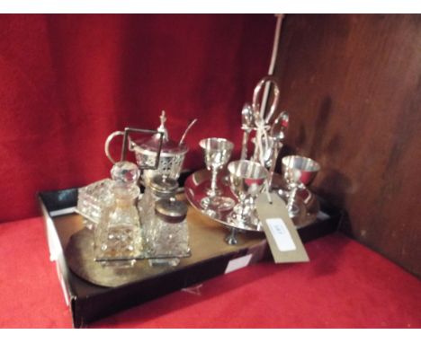 A very ornate silver-plated mustard pot with blue glass liner and silver spoon, a silver-plated egg cup and a silver-plated a