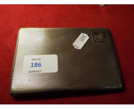A Birmingham silver cigarette case with engine turned decoration and monogram to cartouche, having inscription to gilded inte