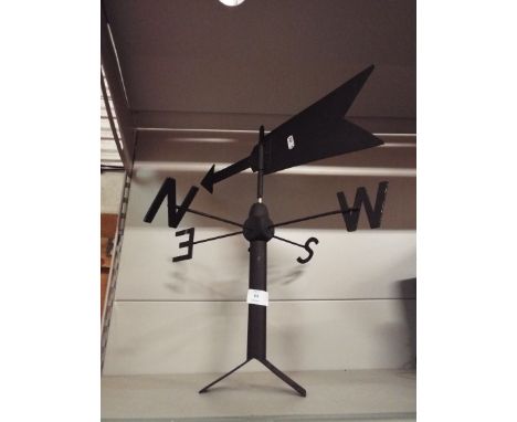 A black painted metal weather vane