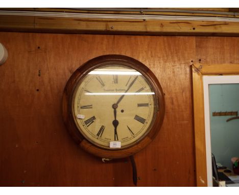 A mid-20thC oak cased circular wall clock the enamel dial with Roman numerals and inscribed Thomas Burtons, Hanley