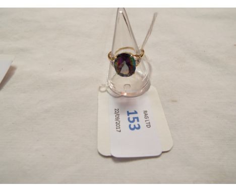 A 9ct gold ring inset with central mystic topaz, size M
