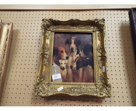 A print of dogs set in an ornate gilt frame