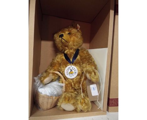 A Steiff 1997 Picnic bear Gold blond 34 he has a porcelain medallion and his basket contains a glass bottle, two porcelain pl