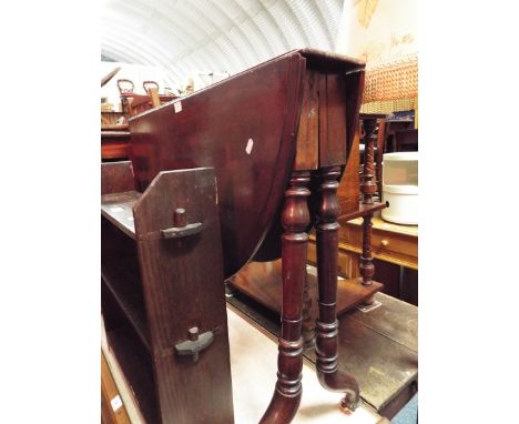 A Victorian mahogany oval folding drop-leaf table raised on unusual turned supports and ceramic castors 