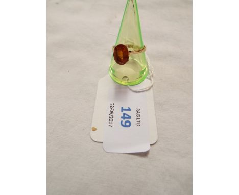 A 9ct gold ring inset with central orange gemstone, size Q
