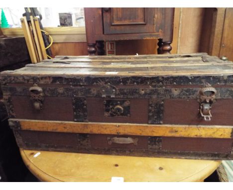 A vintage wooden bound steamer trunk