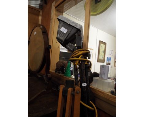 A wooden tripod stand together with a metal tripod lamp