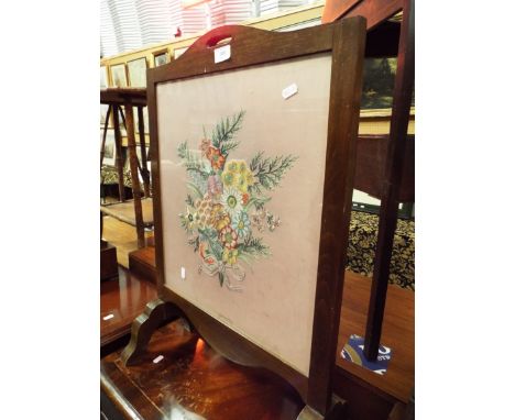 An oak framed fire screen with wool-work inset