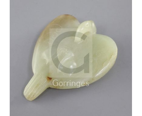A Chinese yellow and russet jade carving of a falcon, Eastern Zhou dynasty or later, the stylised bird carved with scrolls an