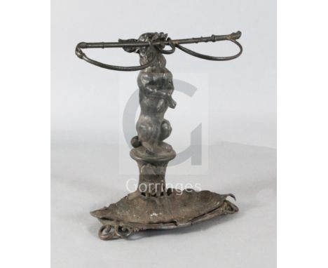 A Victorian Coalbrookdale? cast iron stick stand, modelled as a terrier holding a riding crop, width 24.5in. height 23.5in.