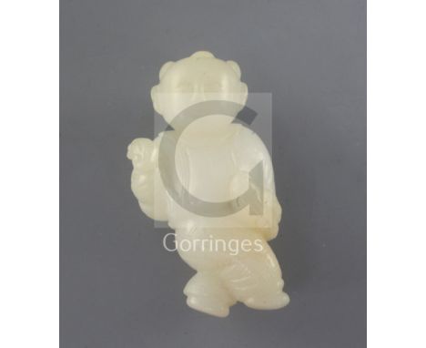 A Chinese white jade figure of a boy holding a bird, 18th/19th century, the stone of good even tone with a hint of russet on 