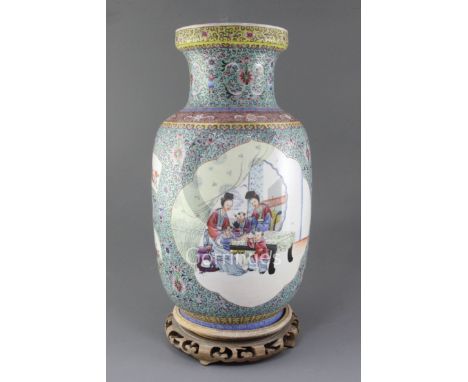 A Chinese famille rose lantern shaped vase, Republic period, painted with children and ladies in an interior within ruyi shap