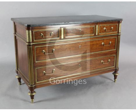 A French Directoire brass mounted mahogany commode, with fossilised marble top, and four long drawers, on toupie feet, W.4ft 