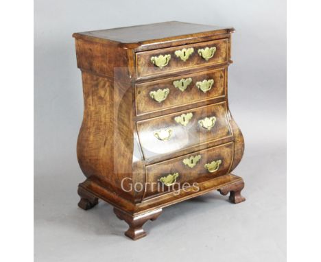 A 19th century Dutch walnut bombe commode, with feather banding, fitted four long drawers, on ogee bracket feet, W.2ft D.1ft 
