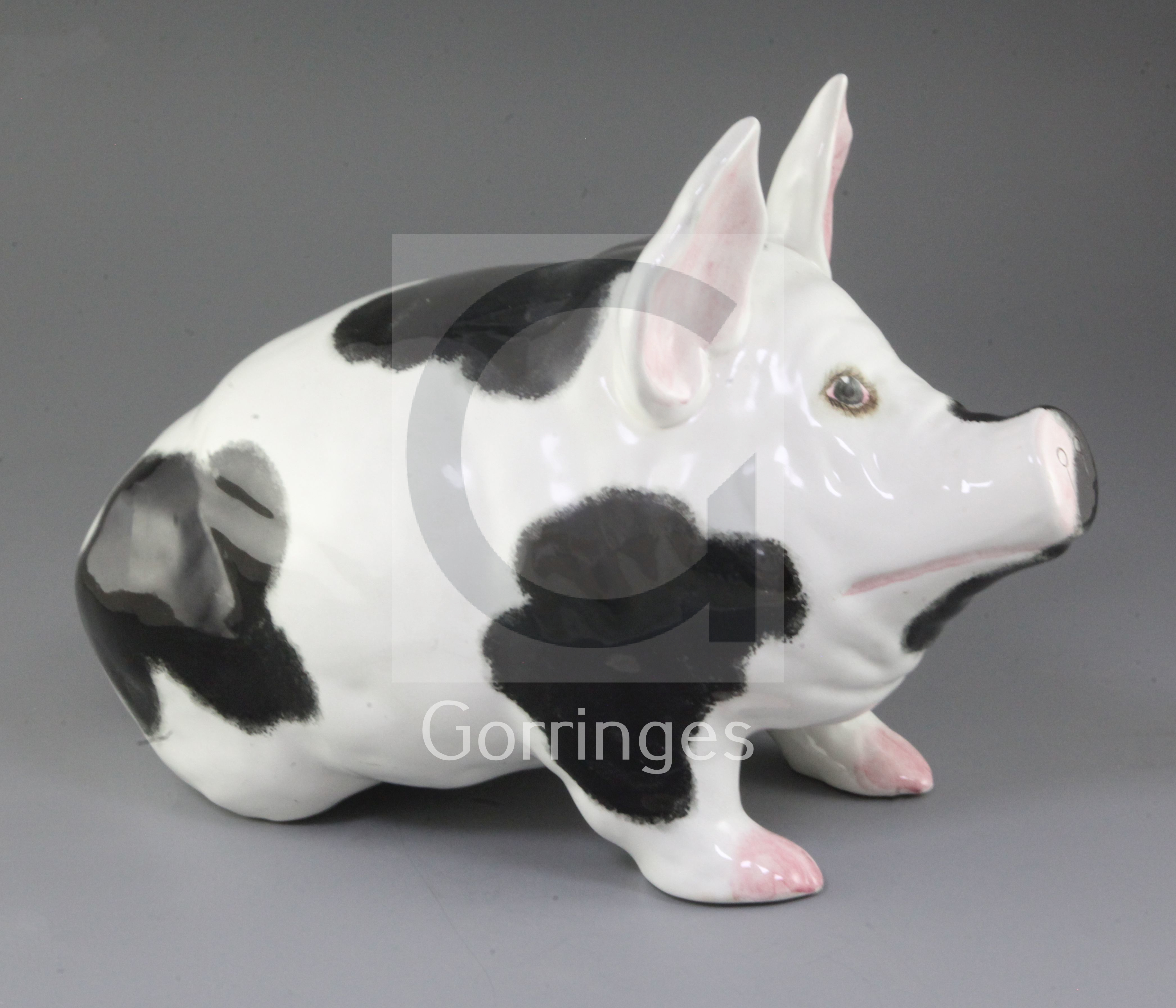 A large Wemyss pottery model of a pig, 20th century, the pig with black ...