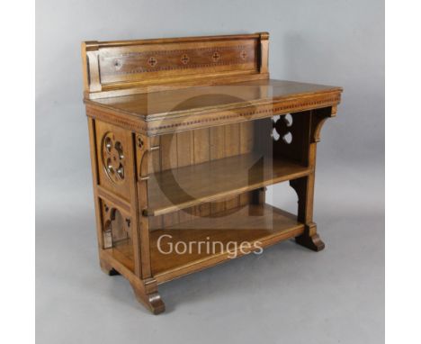 A Holland and Sons Gothic revival oak buffet or serving table, probably designed by Bruce Talbert, with raised panel to the r
