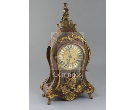 A late 19th century French ormolu mounted red boullework mantel clock, with enamelled tablet numerals, sunburst pendulum and 