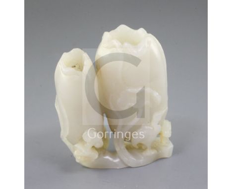 A Chinese white jade 'lotus' small vase, carved in high relief and open work with curled lotus leaves, lingzhi fungus and a c