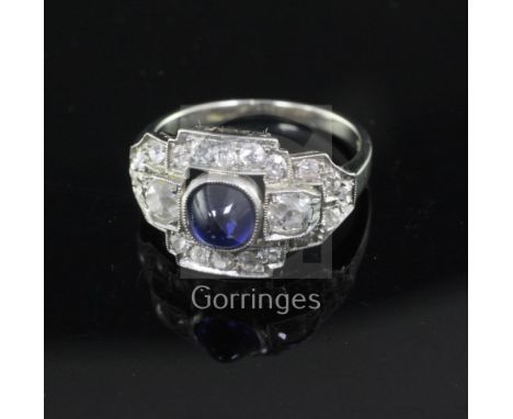 An Art Deco cabochon sapphire and diamond cluster ring, white metal setting (tests as 14ct), size K