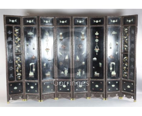 A good Chinese jade, hardstone and rosewood mounted eight fold Coromandel lacquer screen, 19th/20th century, decorated with f