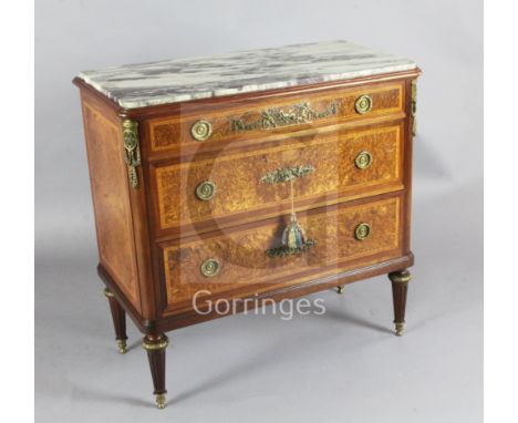 Francois Linke. A fine ormolu mounted tulipwood banded birds eye maple commode, with marble inset top and three long drawers,