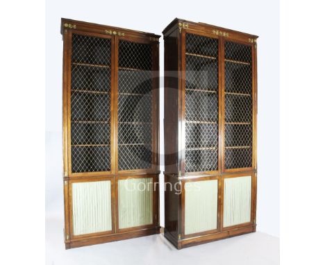 A suite of five Regency rosewood and brass mounted library bookcase cabinets, comprising a breakfront library bookcase, fitte