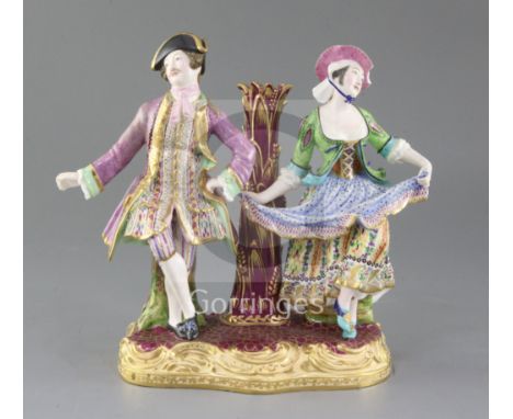 A Minton figure group candlestick. c.1840-5, modelled with a male and female dancer flanking a nozzle, height 21cm, firing cr