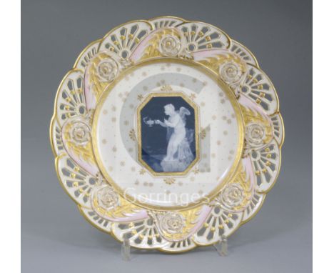 A Mintons pate-sur-pate plate, by Alboin Birks, c.1905, the central panel decorated with a semi nude winged cherub holding an
