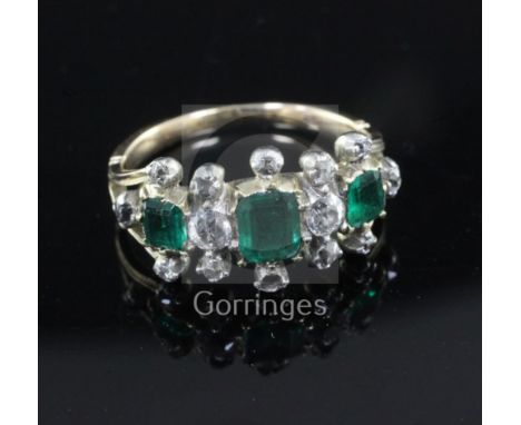 A Georgian gold and silver, three stone emerald and diamond half hoop triple cluster ring, with closed back setting, one ston