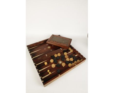 A FOLDING ROSEWOOD BACKGAMMON BOARD the outer part for chequers with boxwood squares, the interior with ivory inlay. Together