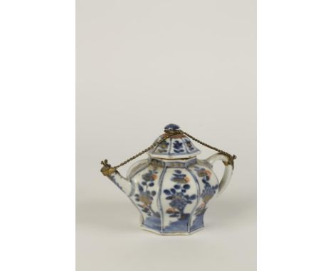 A CHINESE BLUE AND WHITE TEAPOT AND COVER of octagonal shape, painted with flowering plants enriched in gilt and iron red, co