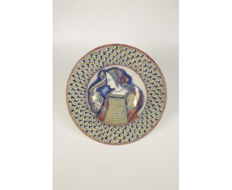 A "DERUTA" POLYCHROME MAIOLICA PORTRAIT DISH of a young woman within a lustre fish scale rim, with an old collectors label, 1