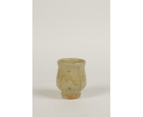 •JIM MALONE (b.1946): A STUDIO POTTERY VASE of footed cup form, incised with a green glaze, impressed marks, 4" high