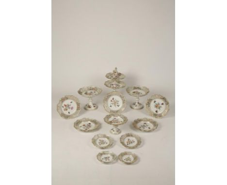 A CONTINENTAL PORCELAIN DESSERT SERVICE with polychrome painted birds amongst flowers within a pierced floral and trellis bor