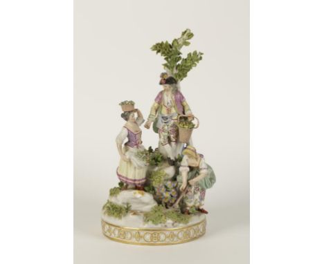 A MEISSEN STYLE CONTINENTAL PORCELAIN GROUP of five labourers working around a tree stump, encrusted with leaves and flowers,