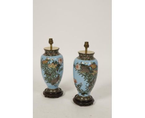 A PAIR OF JAPANESE CLOISONNE ENAMEL VASES each worked with birds amongst flowering plants, on a pale blue ground - adapted fo